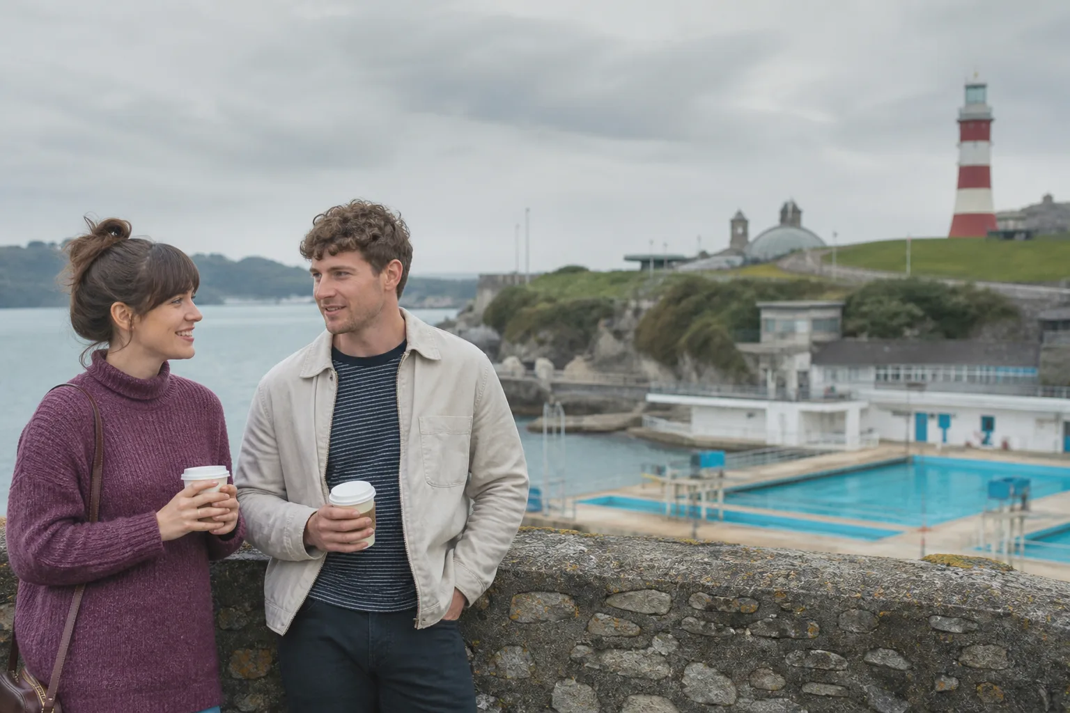 Two people walking together beside Plymouth's waterfront